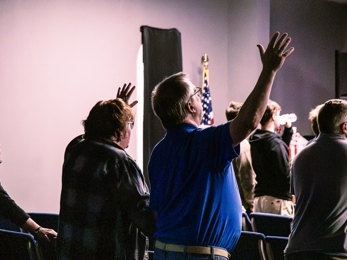 Worshippers with hands raised during a service